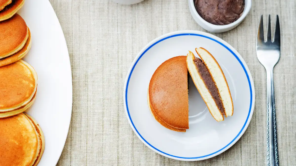 Dorayaki recheado com chocolate em um prato de sobremesa.
